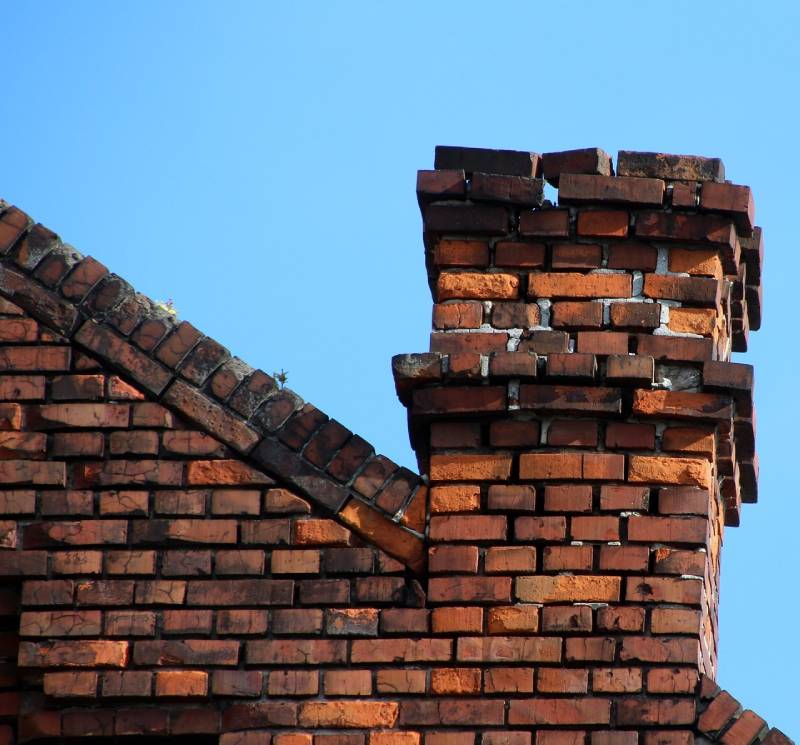 Damaged chimney on an Livonia home showing cracks and missing mortar